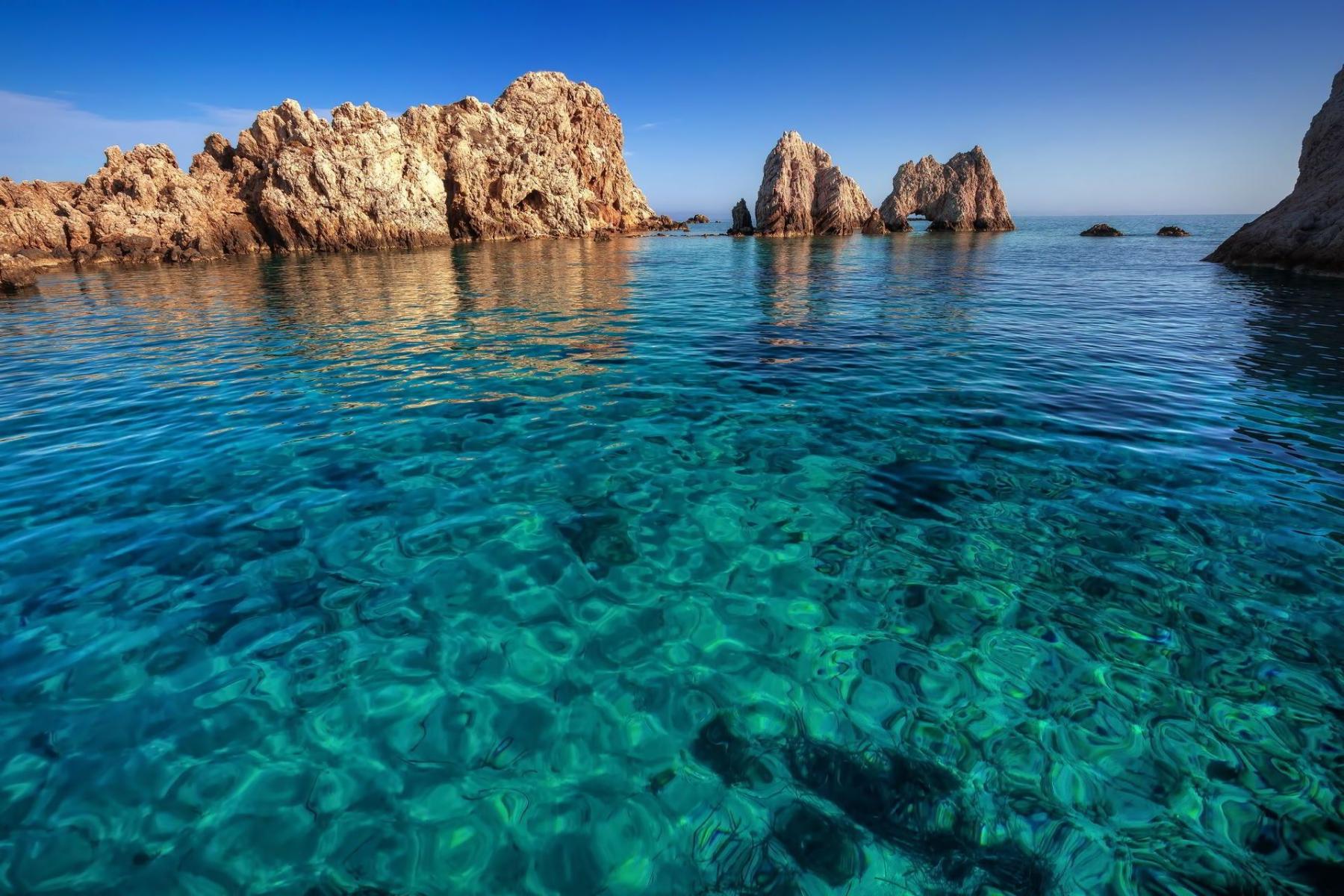 Crystal-clear turquoise waters of a secluded beach in Antiparos, perfect for swimming