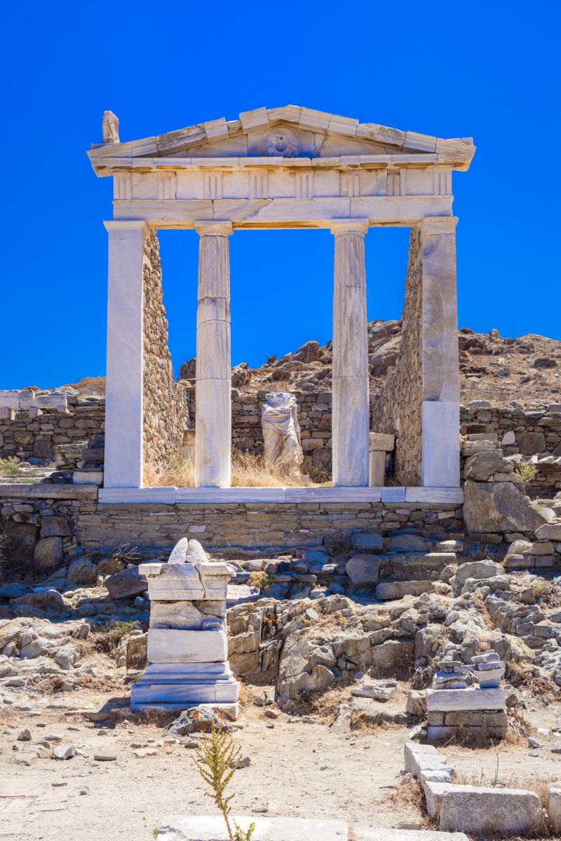 Ruins of an ancient Greek temple under the blue Aegean sky