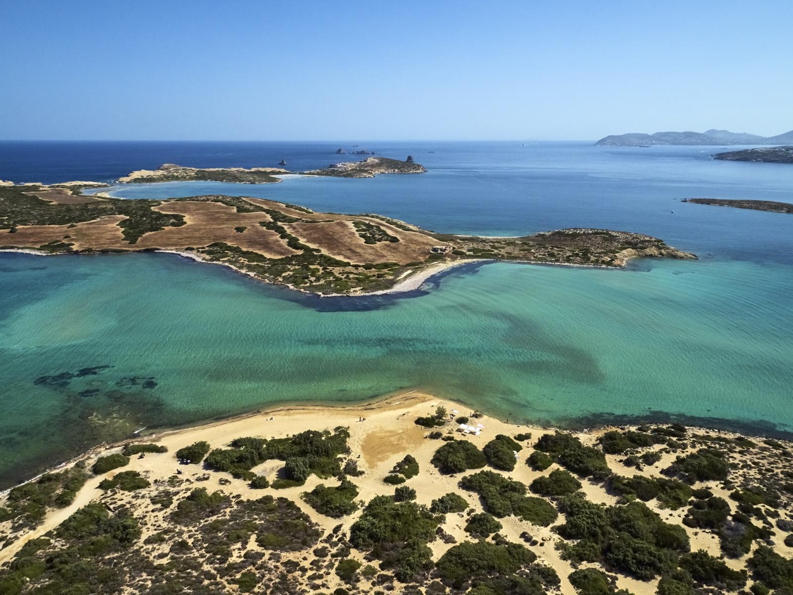 Unspoiled sandy beach on Despotiko Island with crystal-clear turquoise waters.
