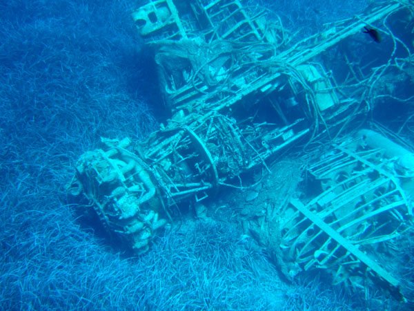 Underwater view of a sunken shipwreck near Irakleia, covered in marine life