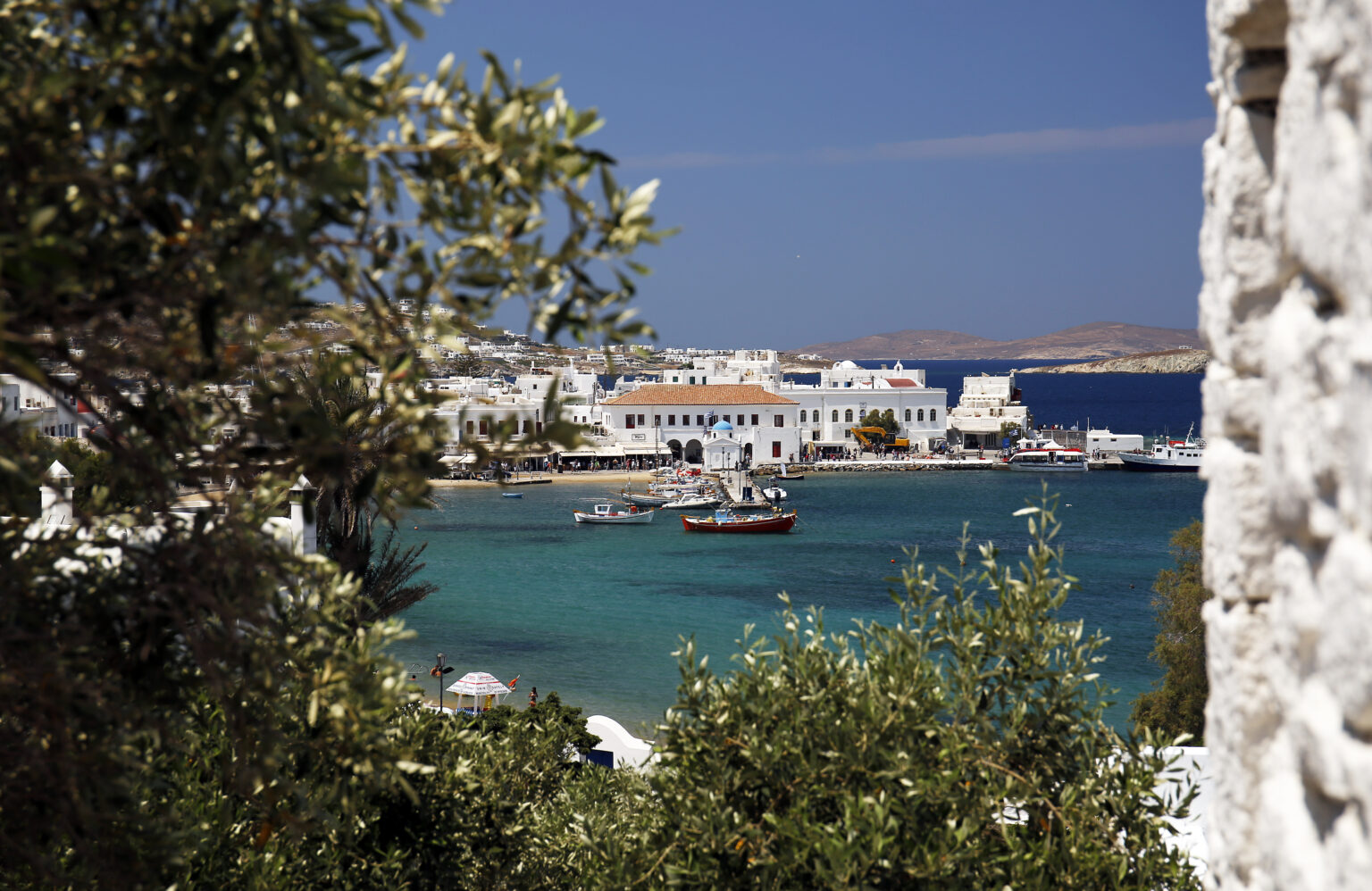 Cobbled streets of Mykonos Town, Greece, with cozy shops and cafes.