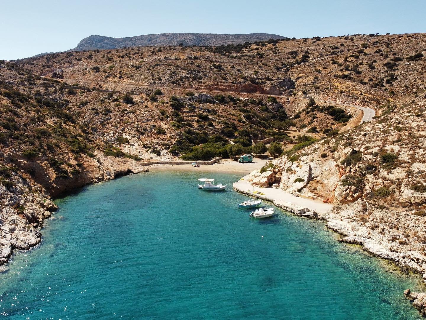 Secluded sandy beach in Schinoussa with crystal-clear turquoise waters and untouched nature.