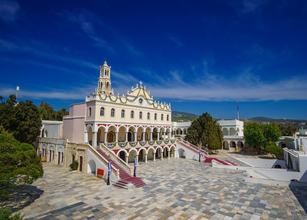 The grand entrance of Panagia Evangelistria, featuring marble steps and a red carpet.