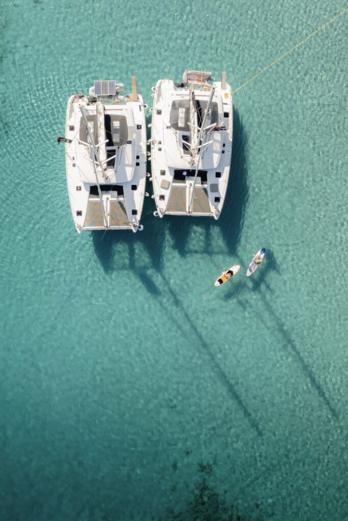 A spacious and elegant catamaran ready for a private yacht charter in Mykonos, perfect for family or group outings