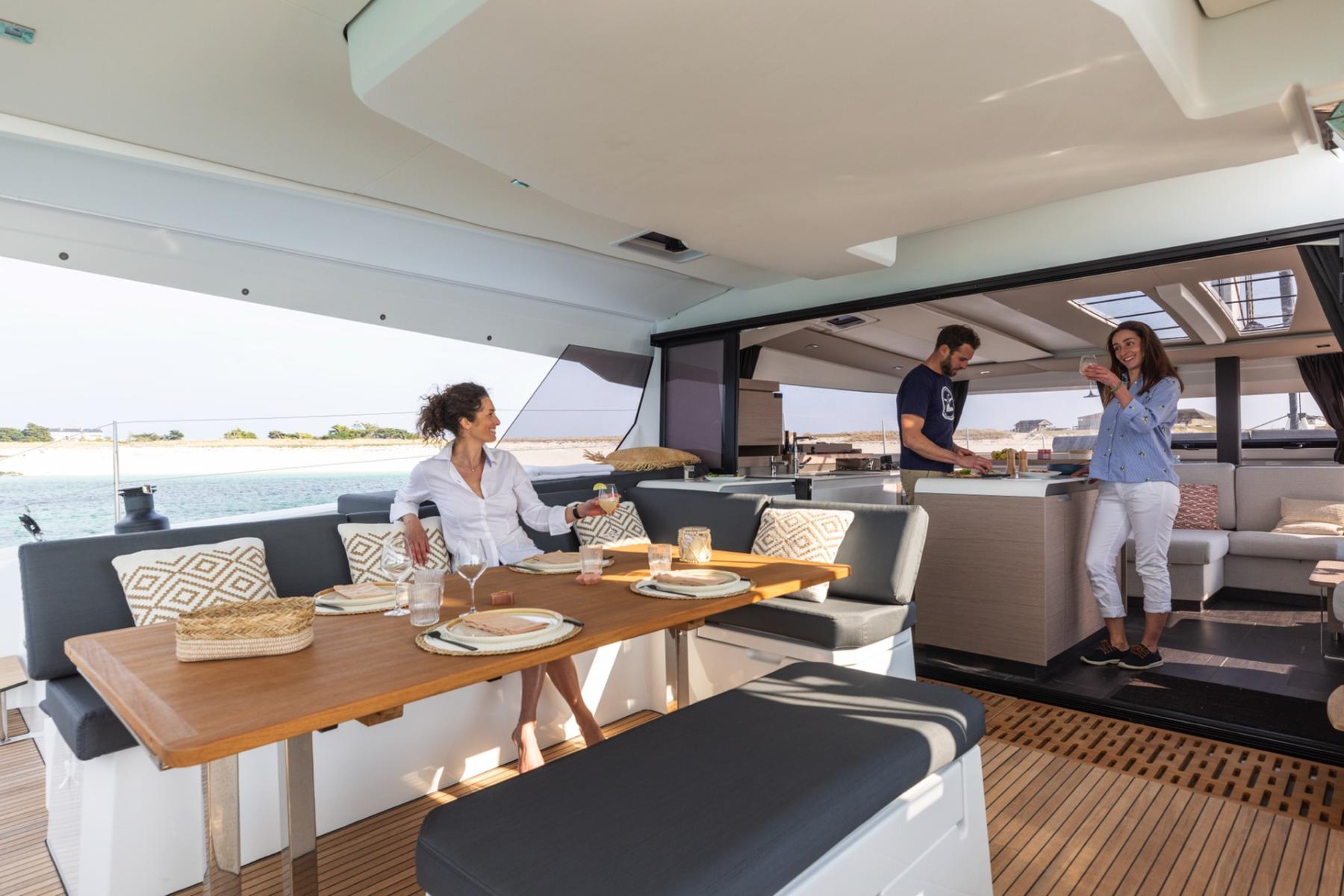 riends Enjoying the Outdoor Deck on a Mykonos Catamaran Charter