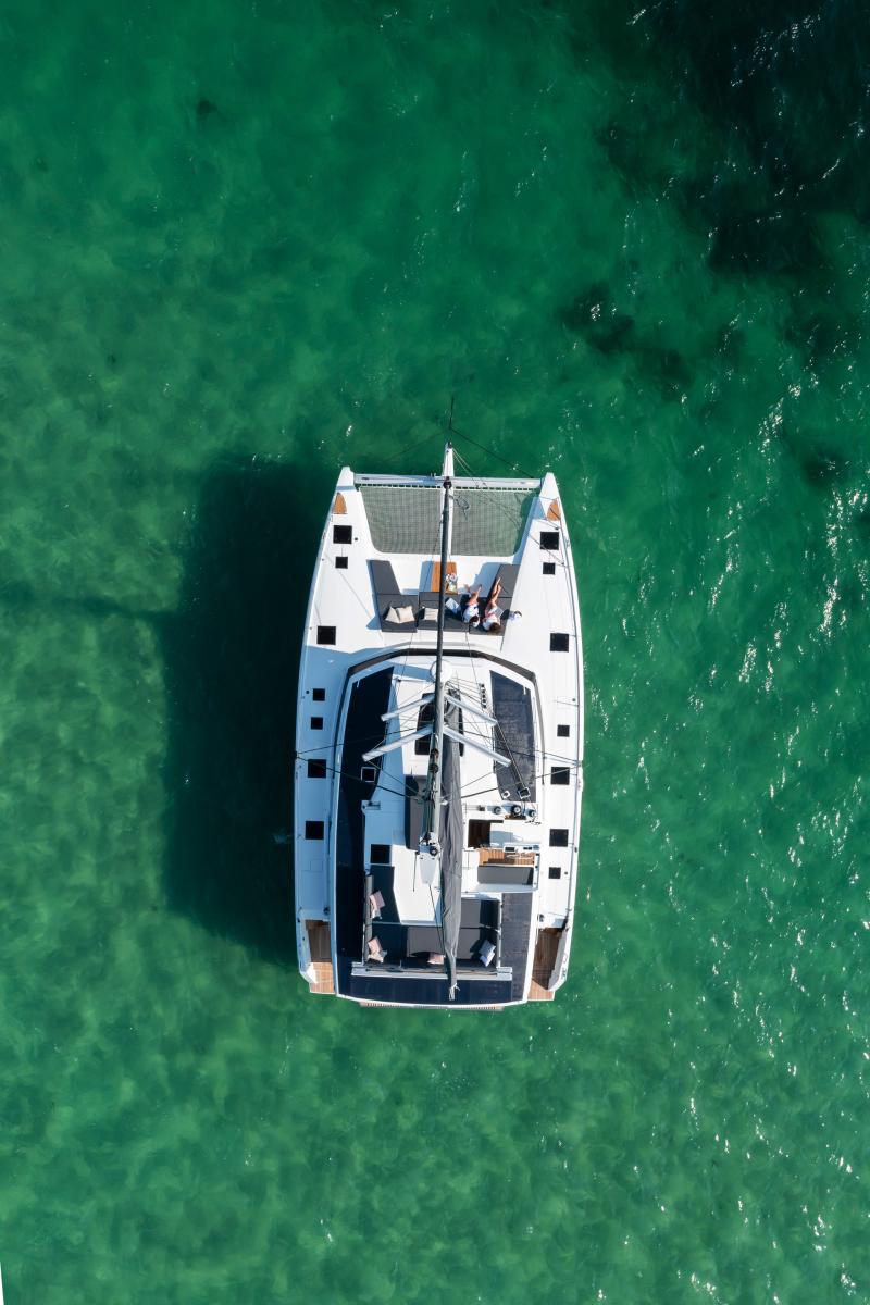 Drone Photo of a Private Catamaran Anchored in a Hidden Mykonos Bay