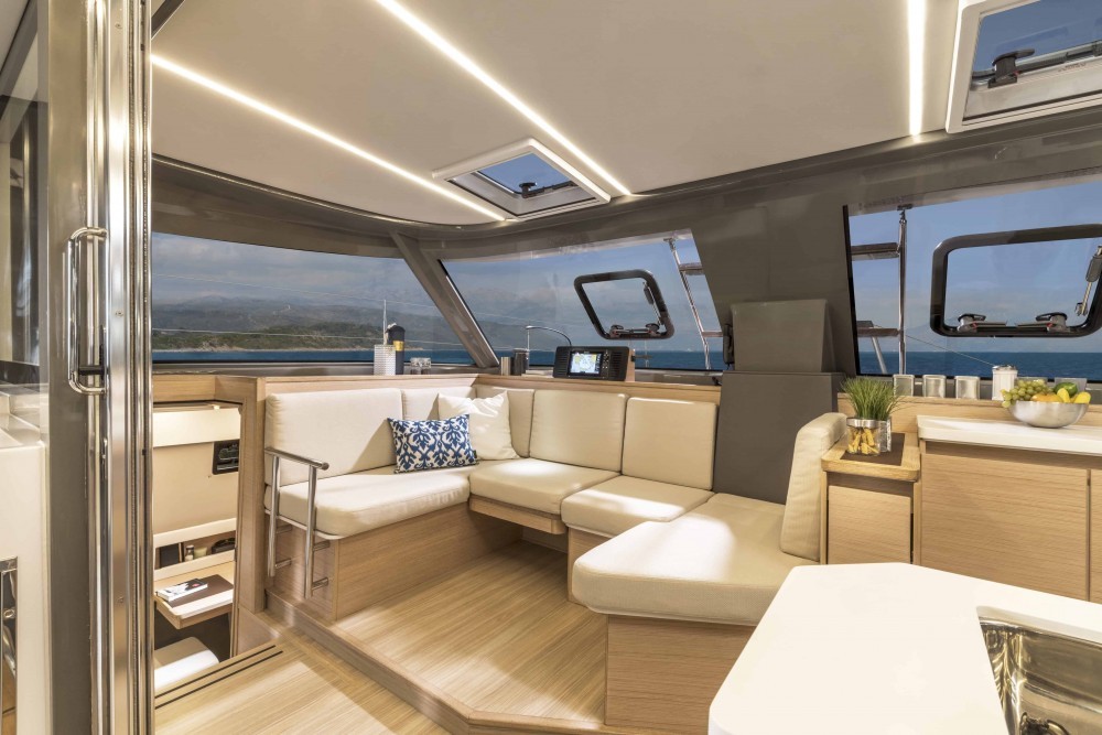 Spacious indoor lounge with large windows, offering stunning Aegean Sea views."
