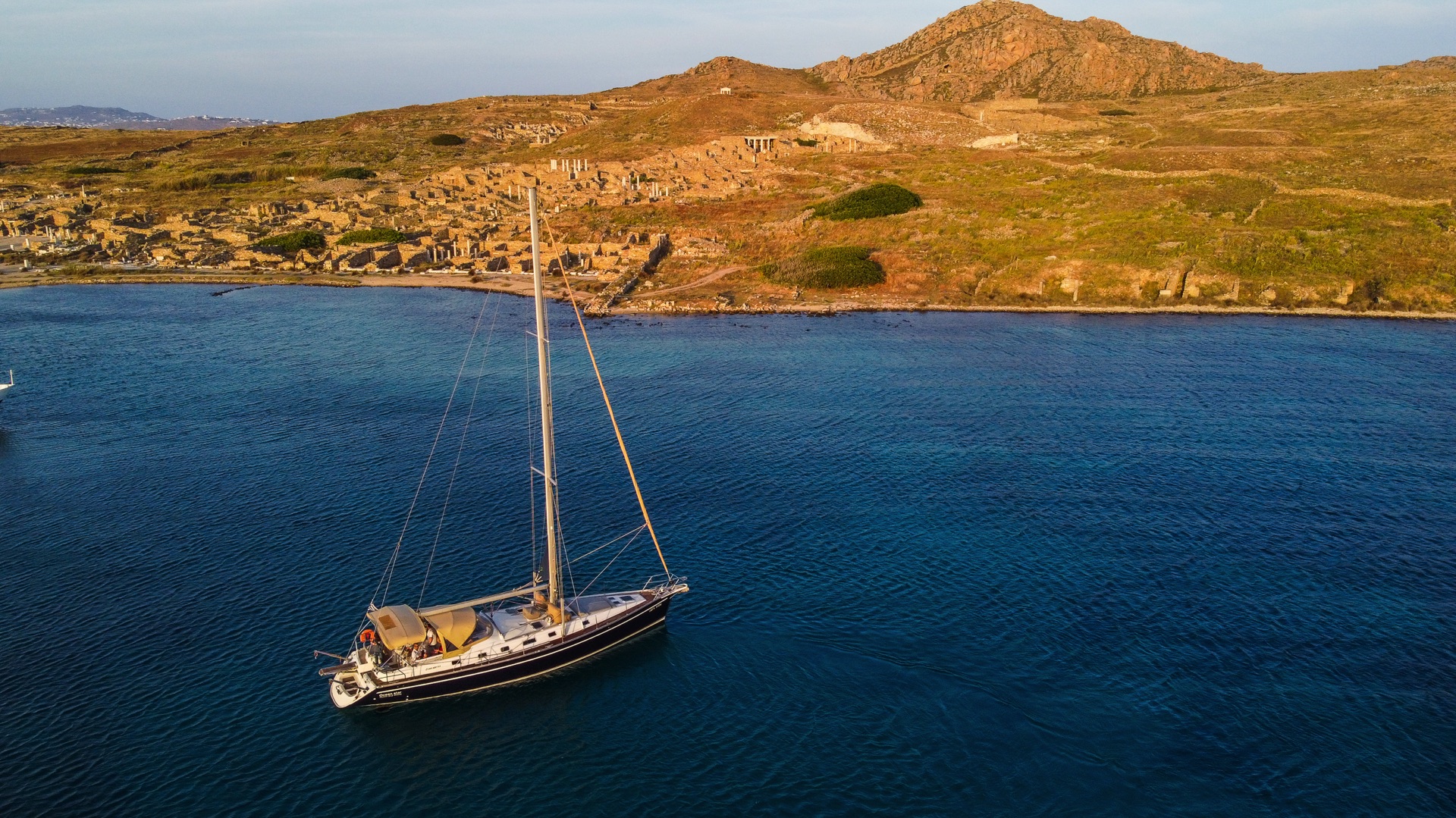 Ancient Ruins of Delos Island – "The iconic ruins of Delos Island, including ancient columns and temples, standing as a testament to Greek history and mythology.