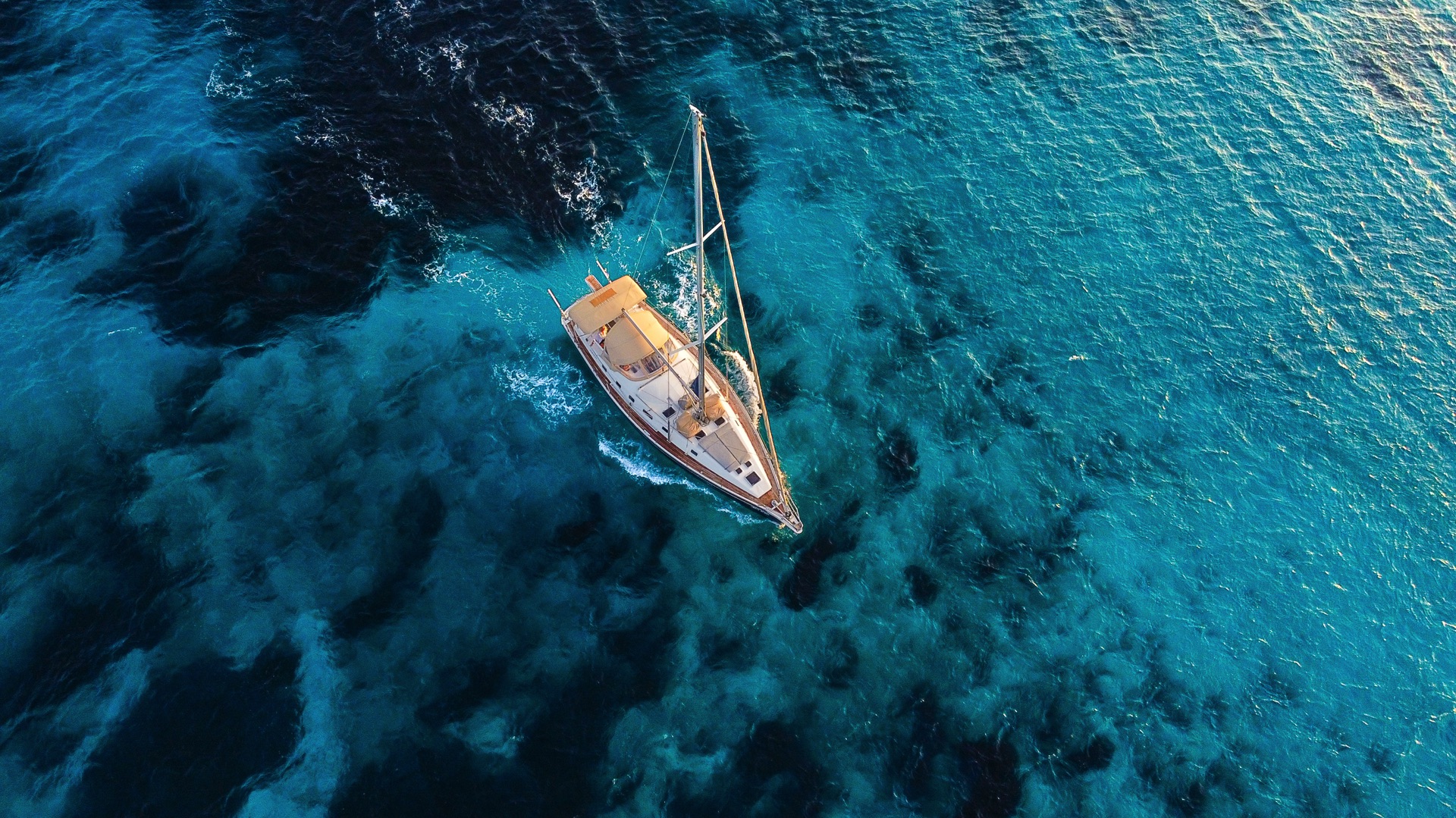 Ocean Star Yacht Under Full Sail – "A majestic view of the Ocean Star sailing yacht with its sails fully extended, moving effortlessly through the sea.