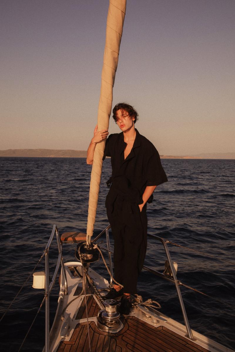 Fashion Photoshoot on a Sailing Yacht – "A model posing elegantly on the deck of a luxury sailing yacht, capturing the essence of high-end yacht fashion.