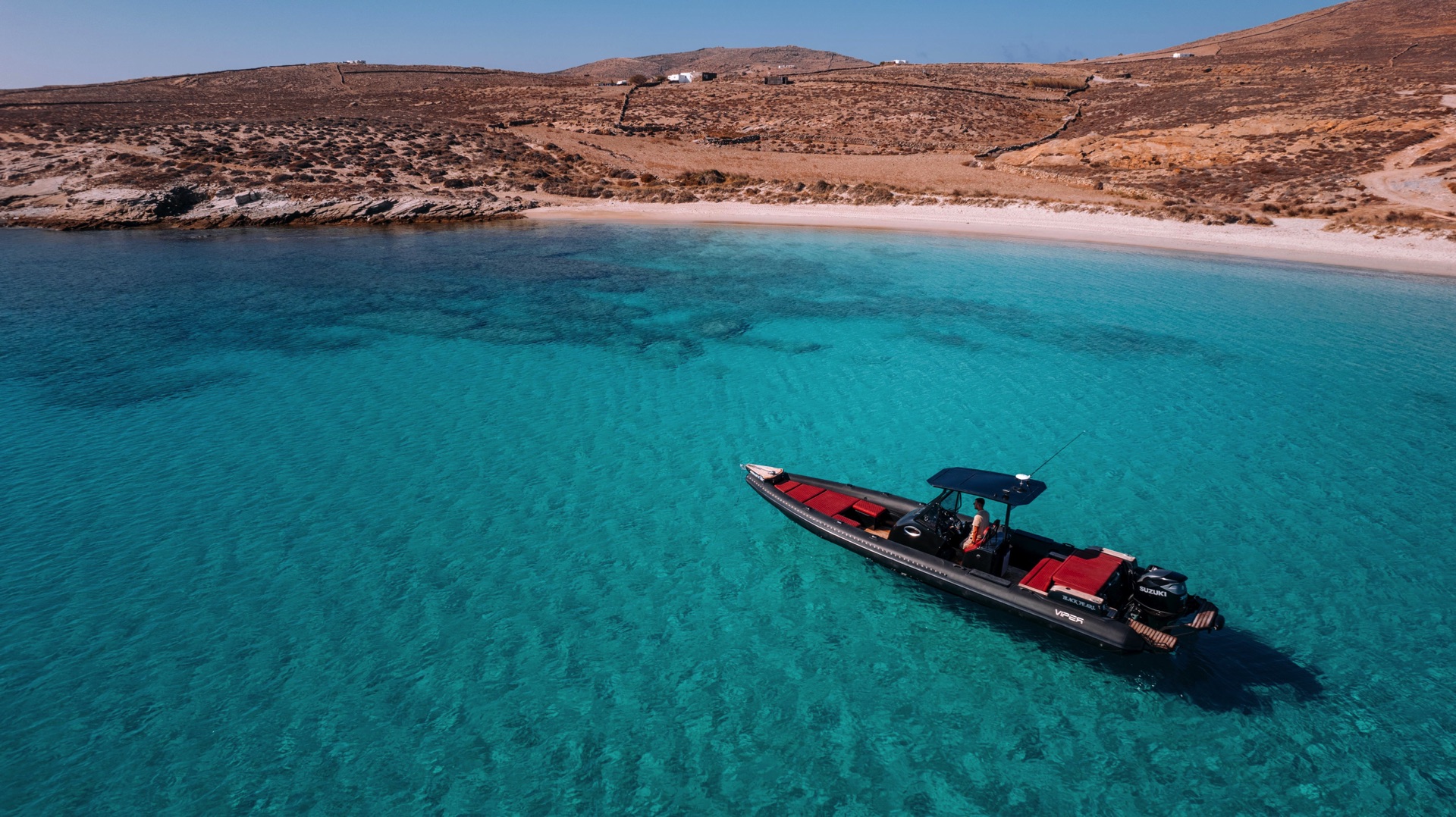 High-speed RIB boat cutting through turquoise waters on a Mykonos island-hopping tour