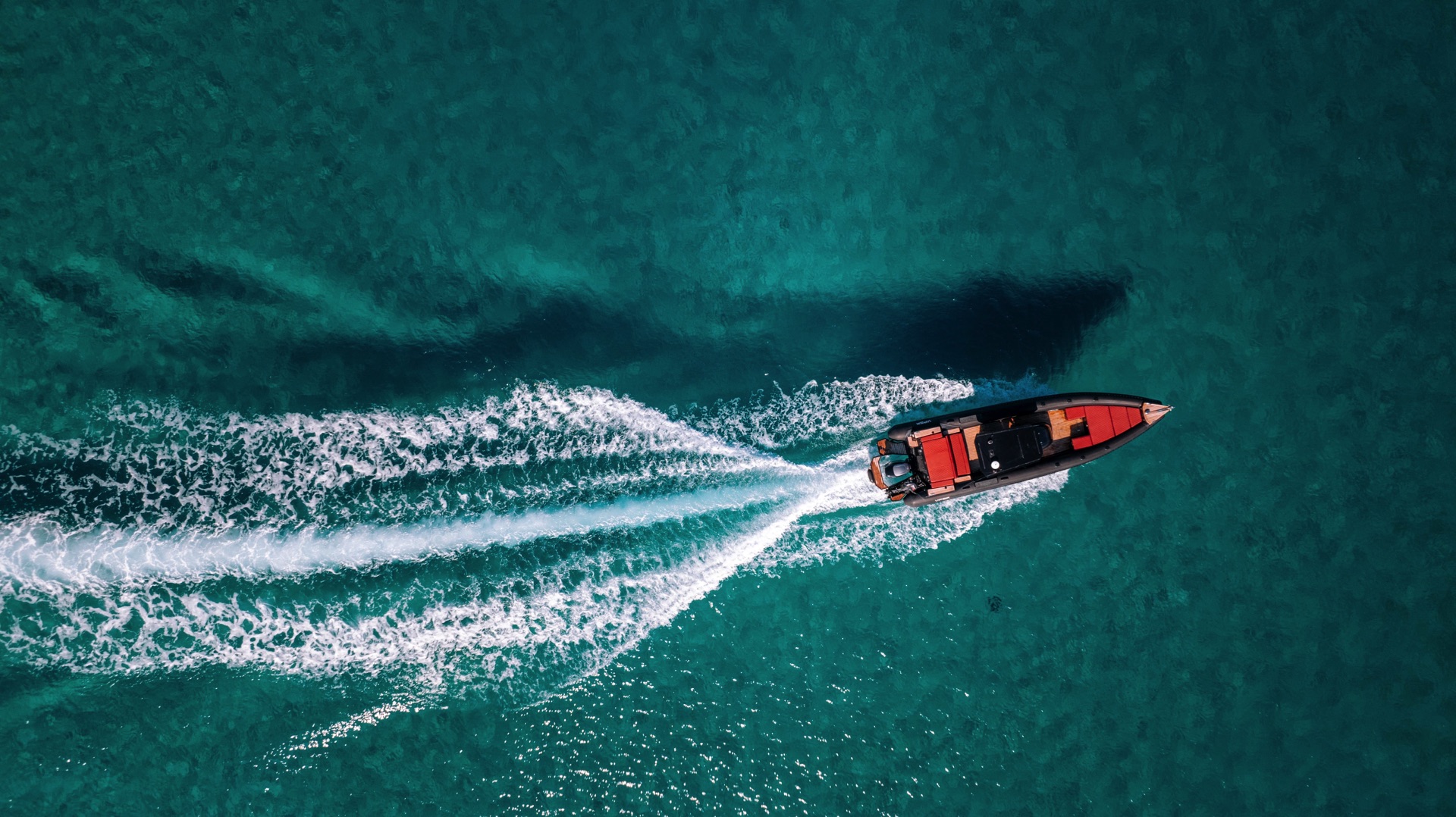 Sleek and modern RIB boat cruising through the Aegean Sea near Mykonos